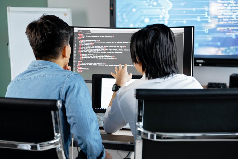 two men looking at a monitor